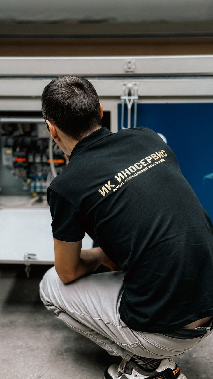 Technician working on complex machinery in an industrial setting.